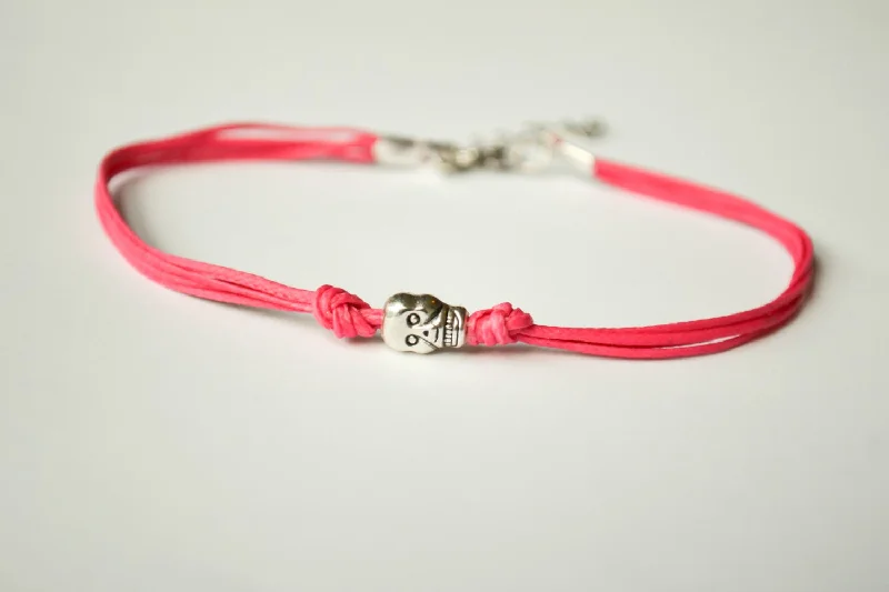 Ladies bracelets with meteor charms -Pink cord bracelet with a silver skull bead charm, gift for her