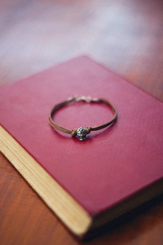 Ladies bracelets for island vibes -Men's bracelet with a silver skull bead charm and a brown cords