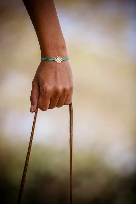 Ladies bracelets with peach citrine -Turquoise cord bracelet with gold endless knot charm