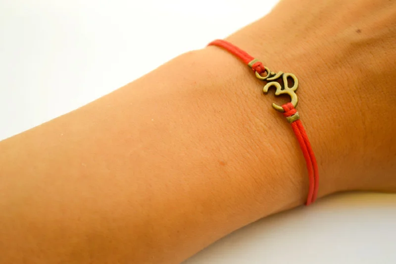 Ladies bracelets bold flair -Red bracelet with bronze tone Om charm, yoga jewelry