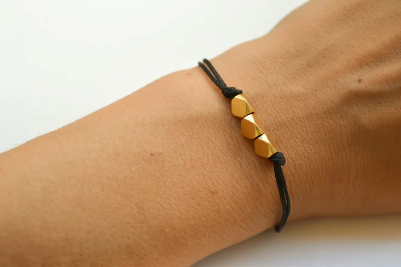 Ladies bracelets with loop symbols -Gold nuggets beads bracelet. black cord, gift for her