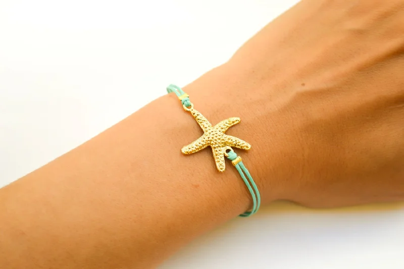 Ladies bracelets quirky bands -Turquoise cord bracelet with a gold starfish charm