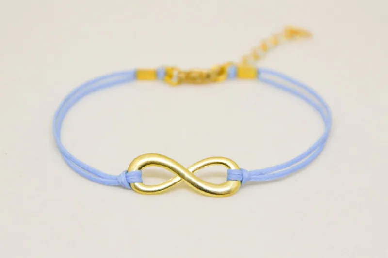 Ladies bracelets with ridge charms -Gold infinity bracelet, womens bracelet with a blue cords, adjustable